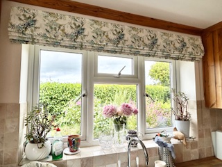 Patterned roman blind fitted in a light modern kitchen