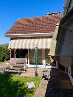 Striped canopy installed over a residential entrance