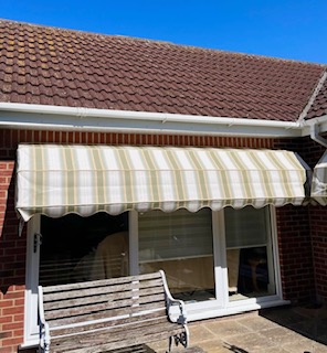 Striped canopy fitted over a doorway for added shade