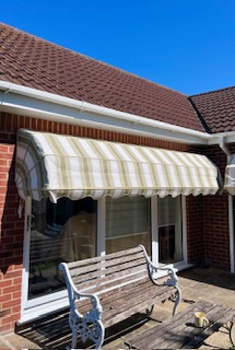 Striped canopy installed above a house entrance