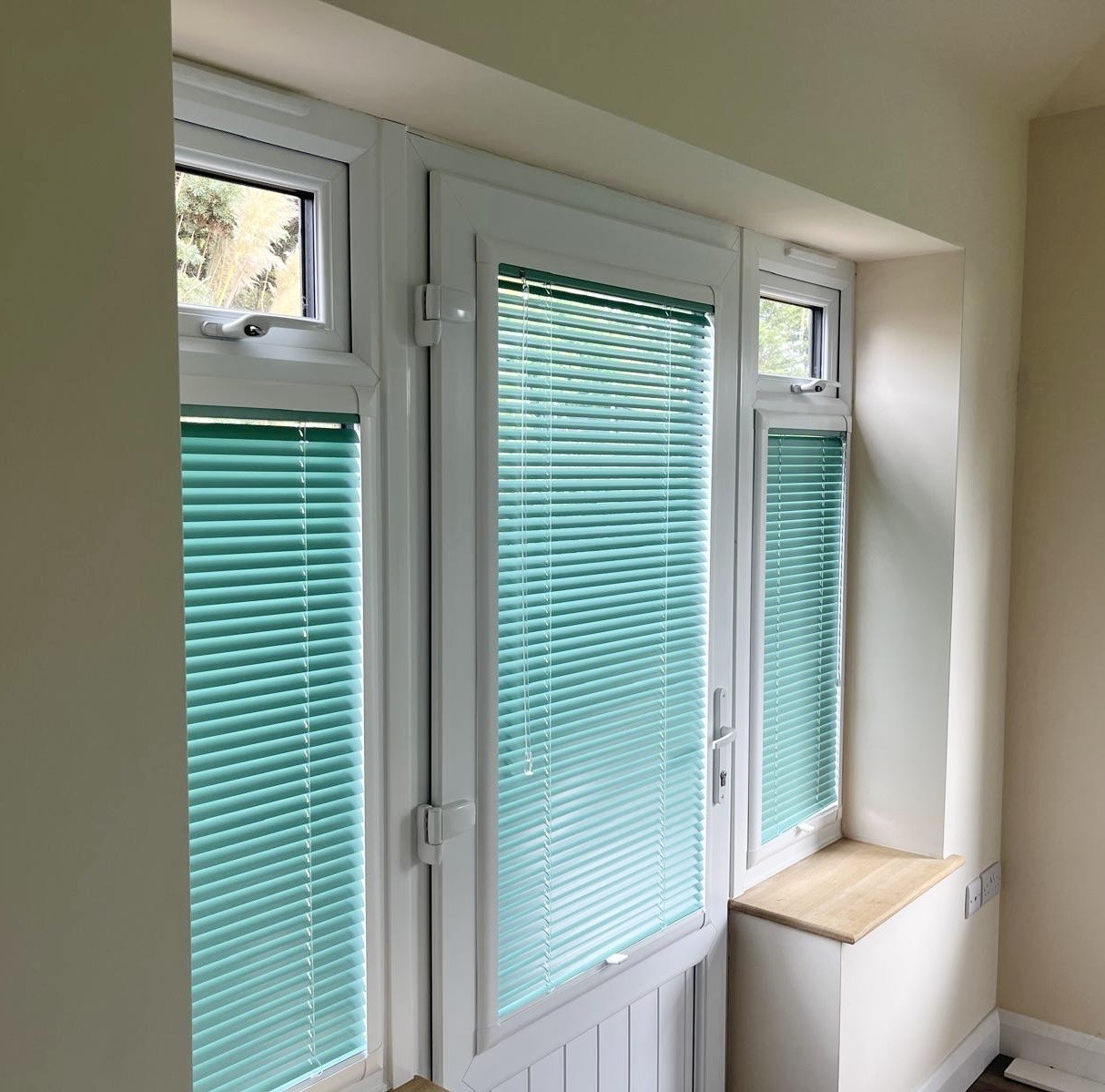 Teal venetian blind fitted to a white patio door