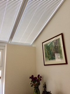 White perfect‑fit roof blinds installed on pitched conservatory ceiling windows in Somerset