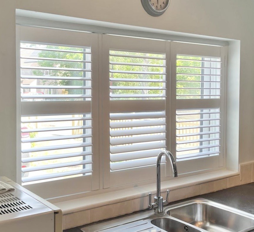 White shutters fitted to a bright modern window