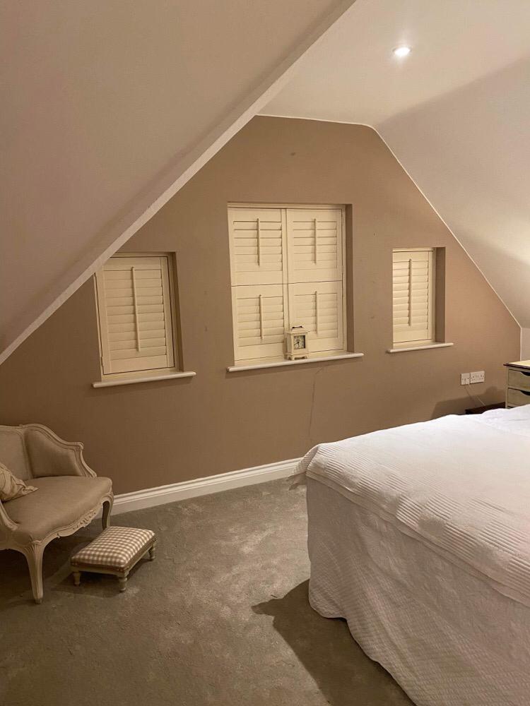White shutters installed on a multi‑panel window