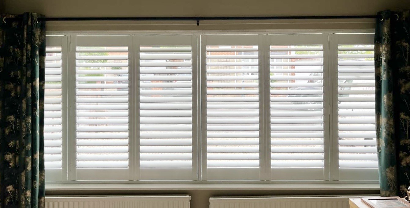 White shutters fitted to a tall feature window