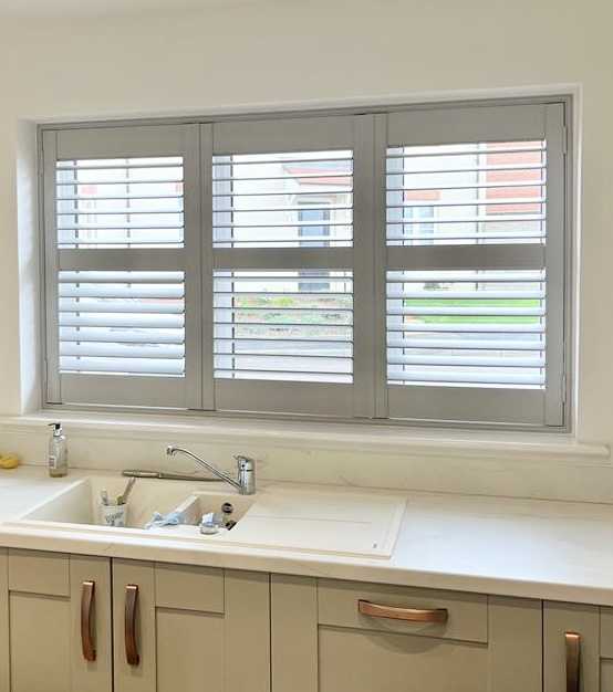 White shutters fitted to a wide window in a modern home